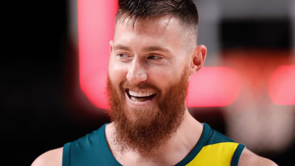 Aron Baynes laughing in an Australian team jersey